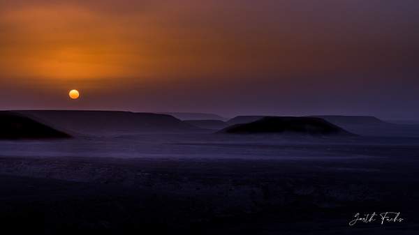 Dusty sunset in Yemeni Desert by Garth Fuchs