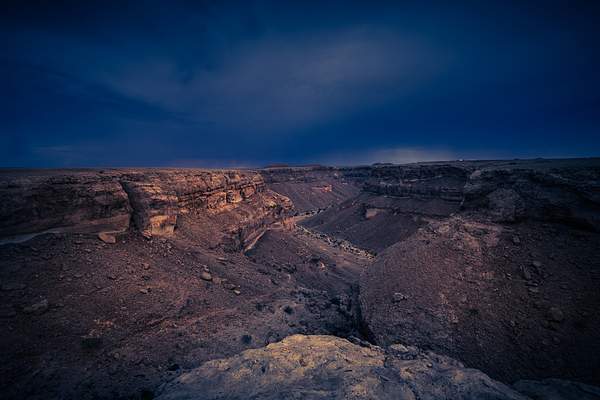 Dark and cloudy wadi in the Yemen by Garth Fuchs