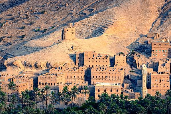Mud village in Yemen desert by Garth Fuchs