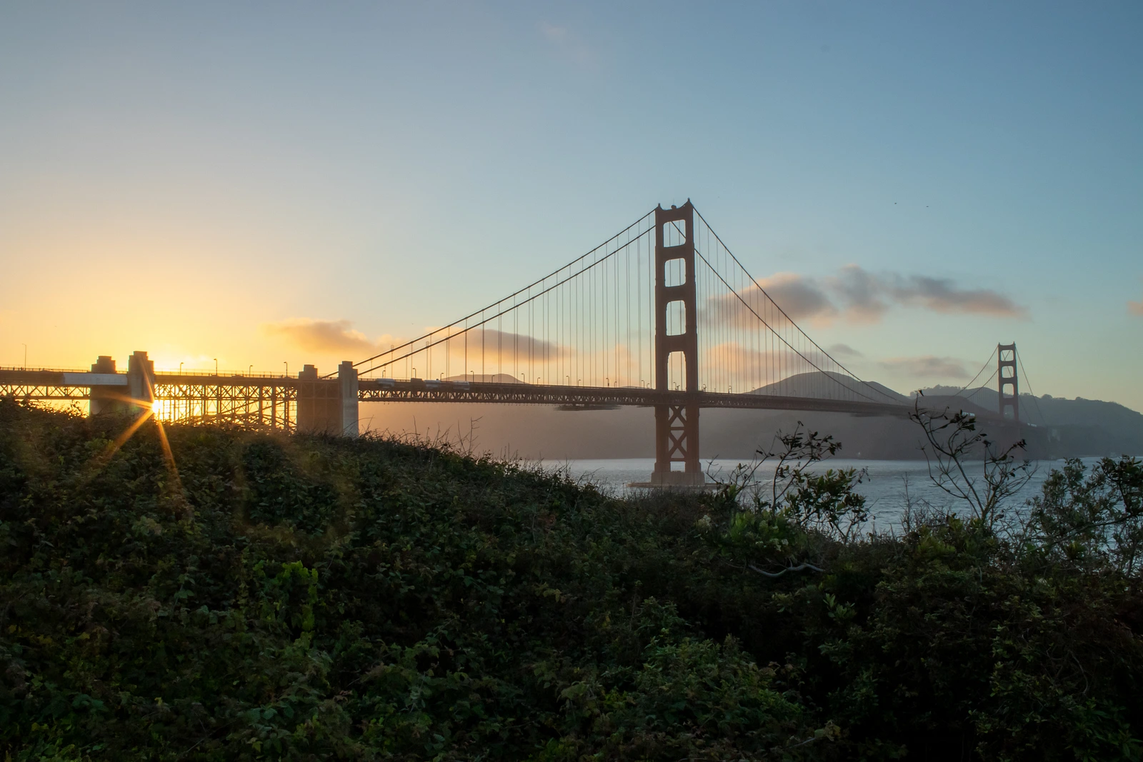 Sunset behind Golden Gate Bridge. Sun over Fort Point.